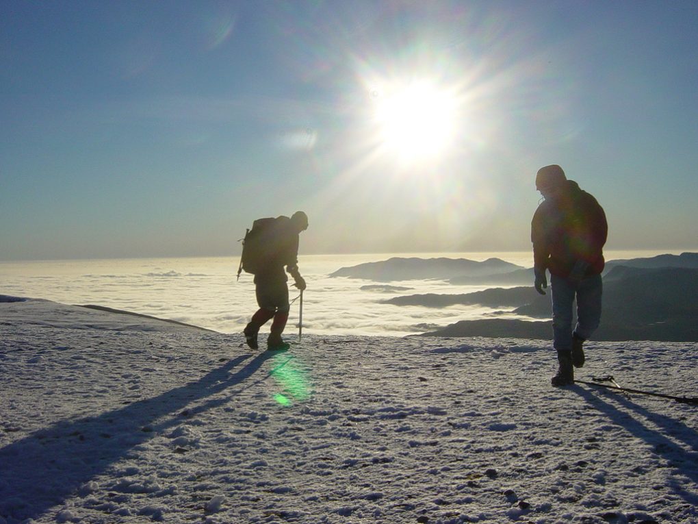 hikers standing on top of helvellyn summit