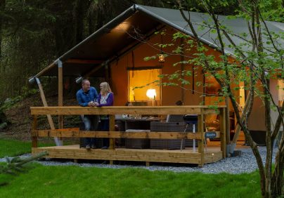 safari tent with couple on the terrace evening